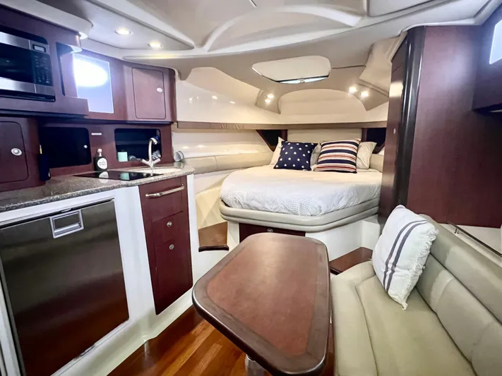  Yacht Photos Pics Luxurious interior of 2011 Boston Whaler 345 Conquest boat with cozy bed and kitchenette.