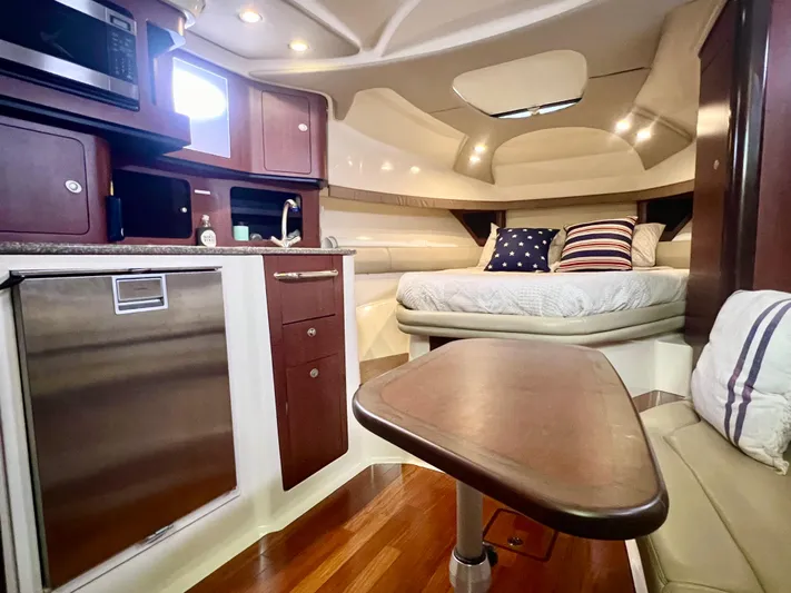  Yacht Photos Pics Luxurious interior of 2011 Boston Whaler 345 Conquest with cozy bed and kitchenette.