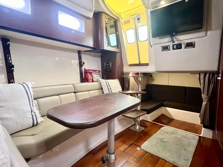  Yacht Photos Pics Interior of 2011 Boston Whaler 345 Conquest, featuring cozy seating and modern amenities.