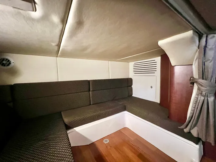 Yacht Photos Pics Interior cabin of 2011 Boston Whaler 345 Conquest with cushioned seating and wood flooring.