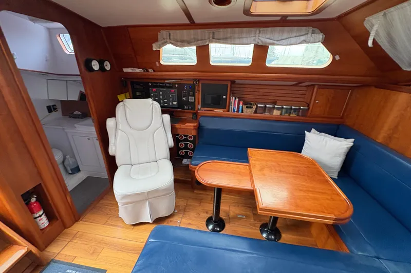 Lino Yacht Photos Pics Interior of 2019 Chatam Extreme 42 yacht with wooden furnishings and blue seating.