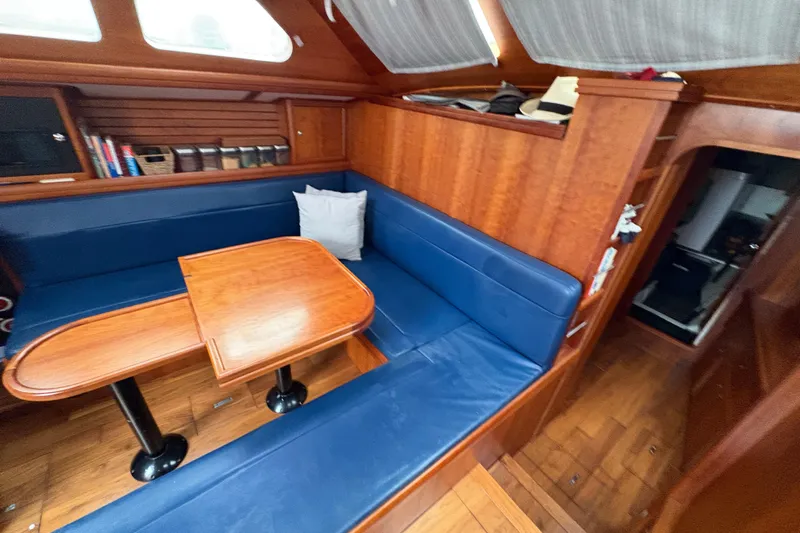 Lino Yacht Photos Pics Interior of 2019 Chatam Extreme 42 yacht with blue seating and wooden table.