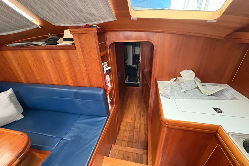 Lino Yacht Photos Pics Interior of 2019 Chatam Extreme 42 yacht with wooden finish and blue seating.