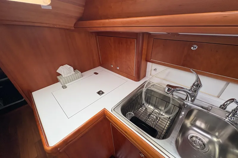 Lino Yacht Photos Pics 2019 Chatam Extreme 42 yacht kitchen with wooden cabinetry and stainless steel sink.