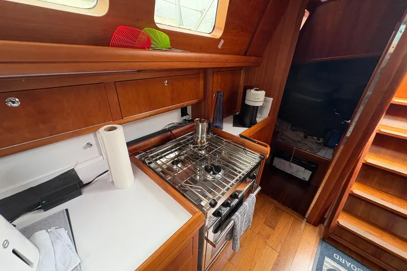 Lino Yacht Photos Pics 2019 Chatam Extreme 42 yacht kitchen with wooden cabinetry and stainless steel stove.