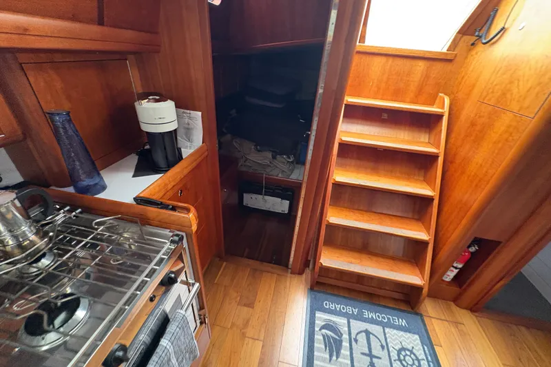 Lino Yacht Photos Pics Interior of 2019 Chatam Extreme 42 yacht with wooden stairs and kitchen area.