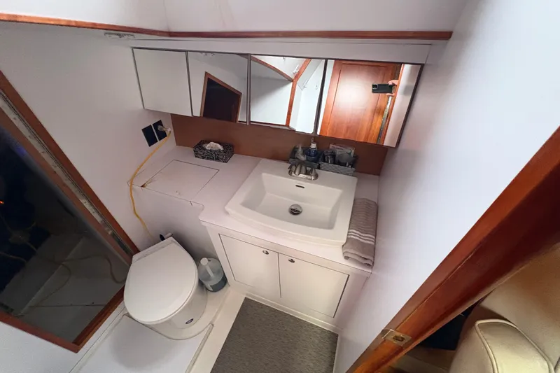 Lino Yacht Photos Pics Bathroom interior of 2019 Chatam Extreme 42 yacht, featuring sink, toilet, and mirror.