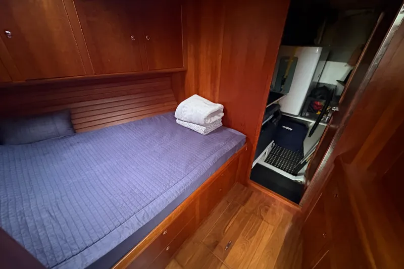 Lino Yacht Photos Pics Cozy cabin interior of 2019 Chatam Extreme 42 yacht with wooden finish and bed.