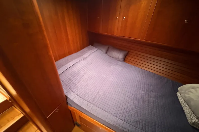 Lino Yacht Photos Pics Cozy cabin interior of 2019 Chatam Extreme 42 with wooden finish and blue bedding.