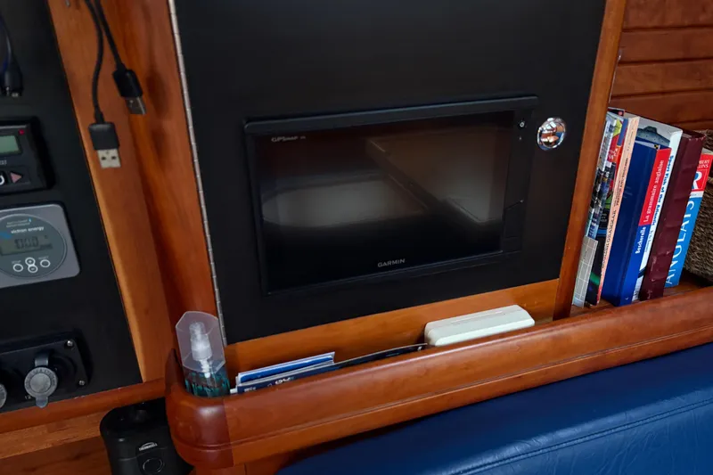 Lino Yacht Photos Pics Control panel and bookshelf inside 2019 Chatam Extreme 42 yacht cabin.