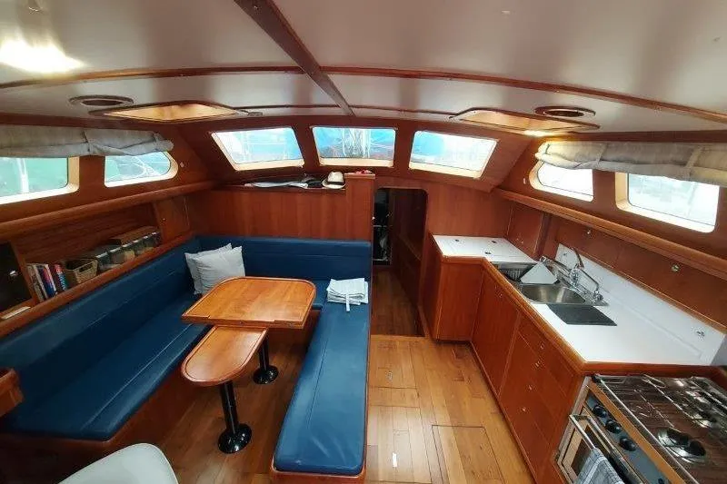 Lino Yacht Photos Pics Interior of 2019 Custom Chatam Extreme 42 yacht with wooden finish and blue seating.