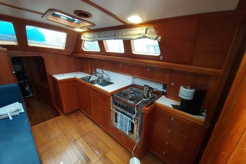 Lino Yacht Photos Pics Interior of 2019 Custom Chatam Extreme 42 yacht with wooden kitchen and appliances.