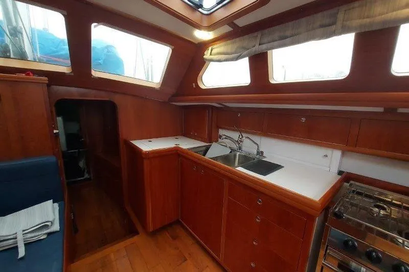 Lino Yacht Photos Pics Interior of 2019 Custom Chatam Extreme 42 sailboat with wooden cabinetry and modern kitchen.