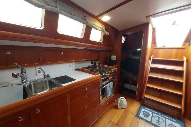 Lino Yacht Photos Pics Interior of 2019 Custom Chatam Extreme 42 yacht with wooden kitchen and stairs.