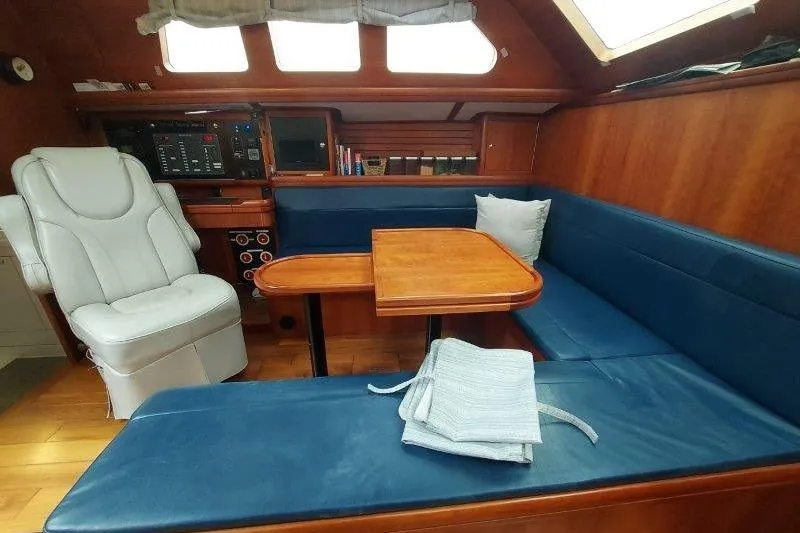 Lino Yacht Photos Pics Interior of 2019 Custom Chatam Extreme 42 yacht with blue seating and wooden table.