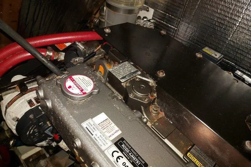 Lino Yacht Photos Pics Engine compartment of 2019 Custom Chatam Extreme 42 with visible components and red hoses.