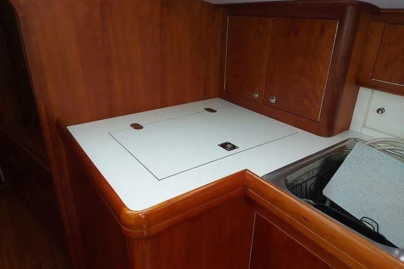 Lino Yacht Photos Pics Wooden kitchen interior of 2019 Custom Chatam Extreme 42 yacht with sink and storage.