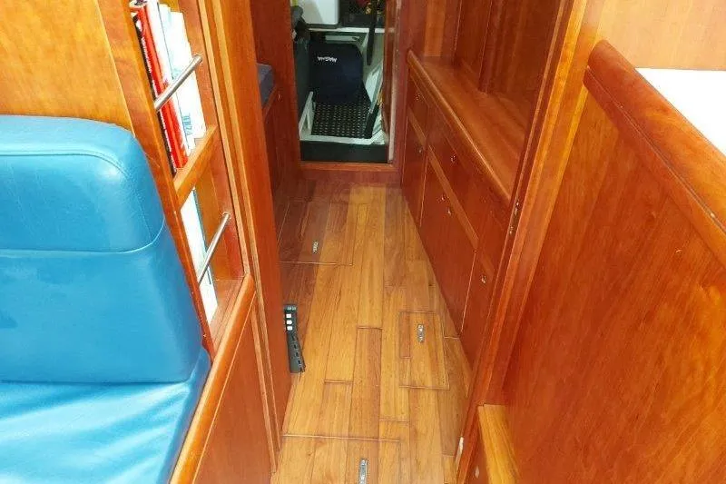 Lino Yacht Photos Pics Interior of 2019 Custom Chatam Extreme 42 yacht with wooden flooring and blue seating.