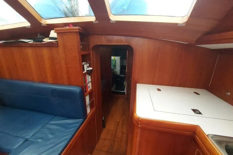 Lino Yacht Photos Pics Interior of 2019 Custom Chatam Extreme 42 yacht with wood finish and blue seating.
