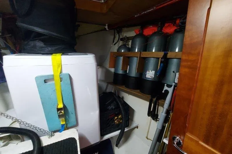 Lino Yacht Photos Pics Laundry area with washing machine and scuba tanks on a 2019 Custom Chatam Extreme 42 boat.