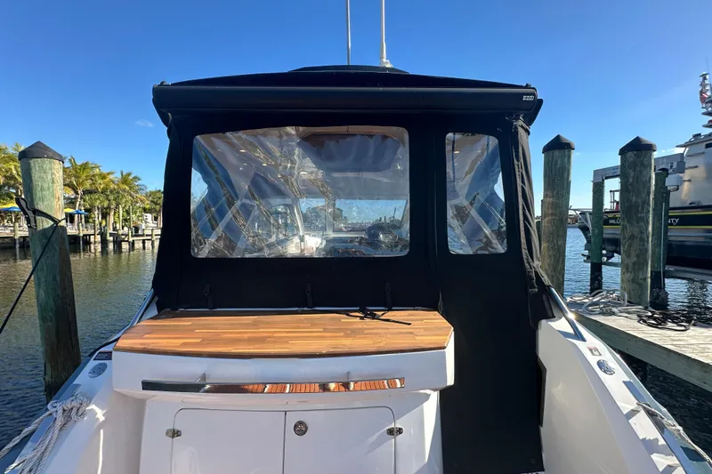  Yacht Photos Pics 2025 NX Boats 370 docked, featuring a sleek design and covered cockpit area.