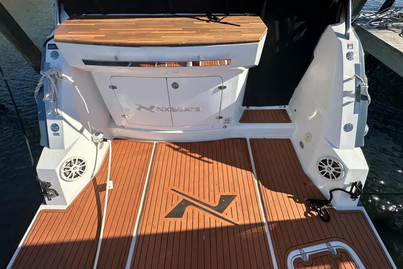  Yacht Photos Pics 2025 NX Boats 370 deck with wood finish and branded logo.