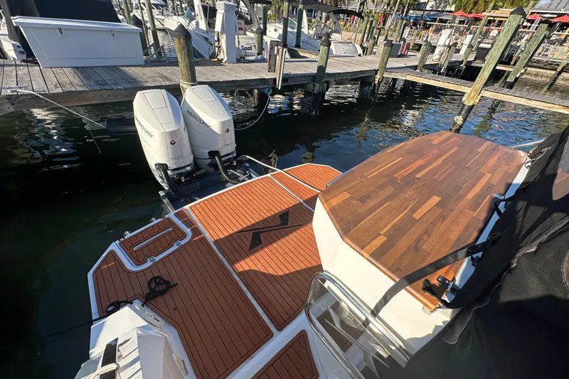  Yacht Photos Pics 2025 NX Boats 370 with dual Mercury engines docked at a marina.