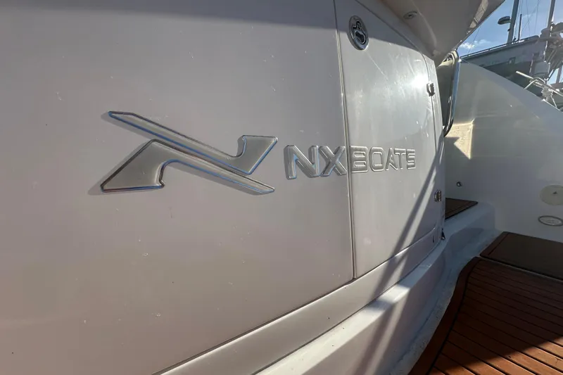  Yacht Photos Pics 2025 NX Boats 370 logo on sleek white boat exterior.