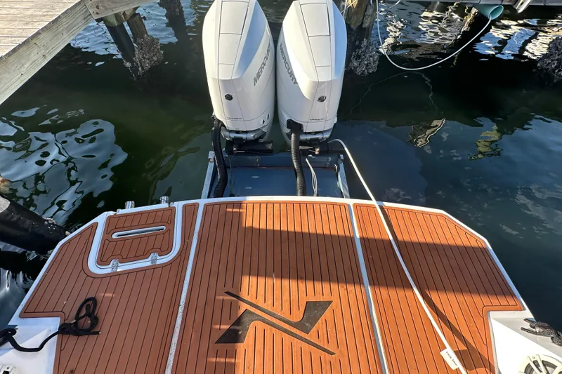  Yacht Photos Pics 2025 NX Boats 370 with dual Mercury outboard engines, docked on wooden platform.