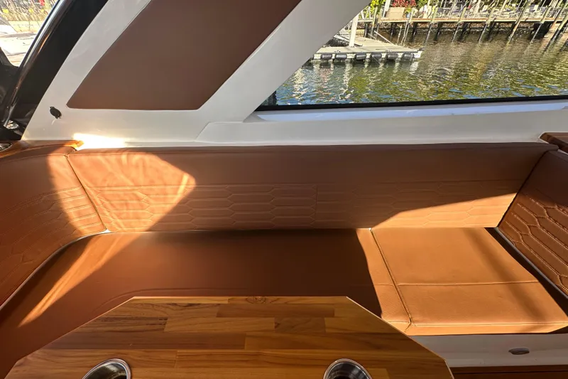  Yacht Photos Pics Luxurious interior of 2025 NX Boats 370 with brown leather seating and wood accents.