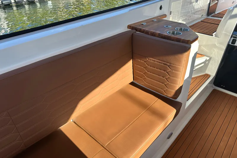  Yacht Photos Pics Luxurious seating on 2025 NX Boats 370 with elegant brown upholstery and cup holders.