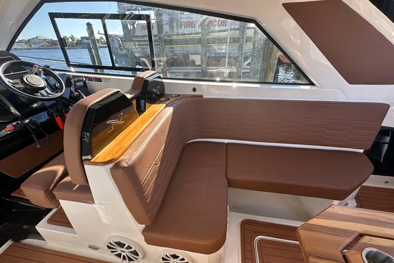  Yacht Photos Pics 2025 NX Boats 370 interior with brown leather seating and modern steering wheel.