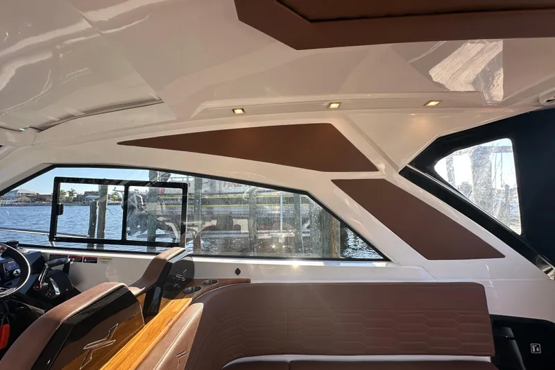  Yacht Photos Pics Interior of 2025 NX Boats 370, featuring sleek design and luxurious seating by the water.