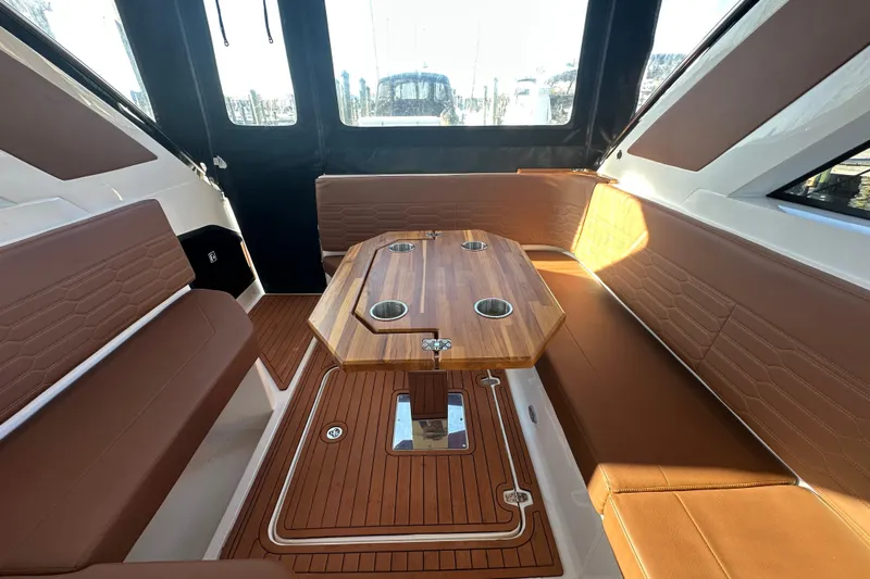  Yacht Photos Pics Interior of 2025 NX Boats 370 with brown seating and wooden table.
