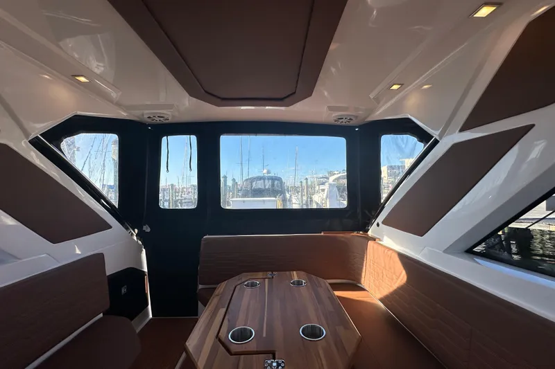  Yacht Photos Pics Interior of 2025 NX Boats 370, featuring sleek design and panoramic windows at a marina.