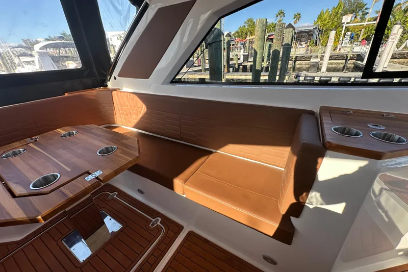  Yacht Photos Pics Luxurious interior of 2025 NX Boats 370 with elegant seating and wooden table.