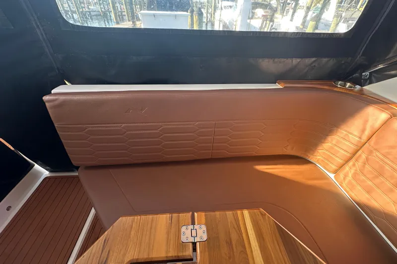  Yacht Photos Pics Luxurious brown leather seating in 2025 NX Boats 370 interior, featuring elegant wood accents.