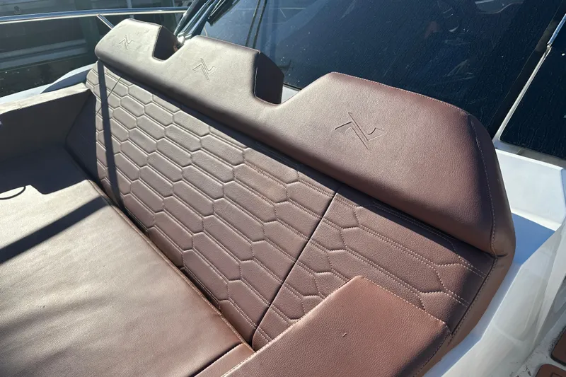  Yacht Photos Pics Luxurious brown leather seating on 2025 NX Boats 370, featuring hexagonal stitching design.