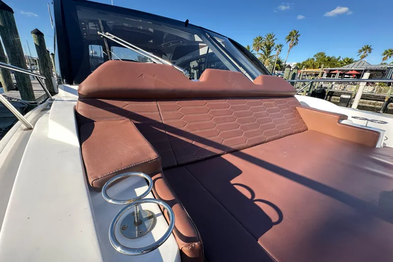  Yacht Photos Pics 2025 NX Boats 370 with brown leather seating and cup holders, docked under clear skies.