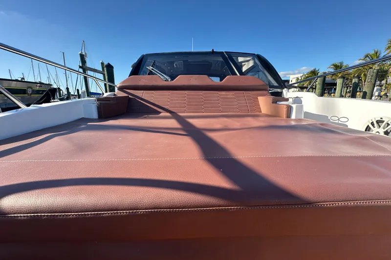  Yacht Photos Pics 2025 NX Boats 370 with brown leather seating, docked under clear blue sky.