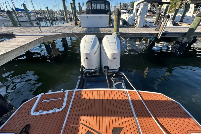  Yacht Photos Pics 2025 NX Boats 370 with dual Mercury outboard engines docked at a marina.