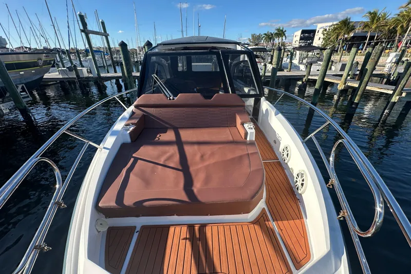  Yacht Photos Pics 2025 NX Boats 370 yacht with sun deck, docked at marina under clear sky.