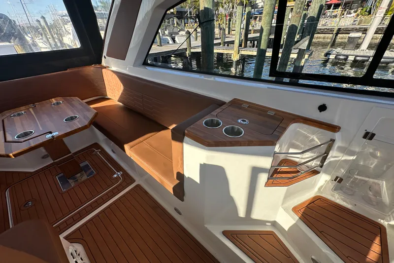  Yacht Photos Pics Luxurious interior of 2025 NX Boats 370 with wood accents and seating area.