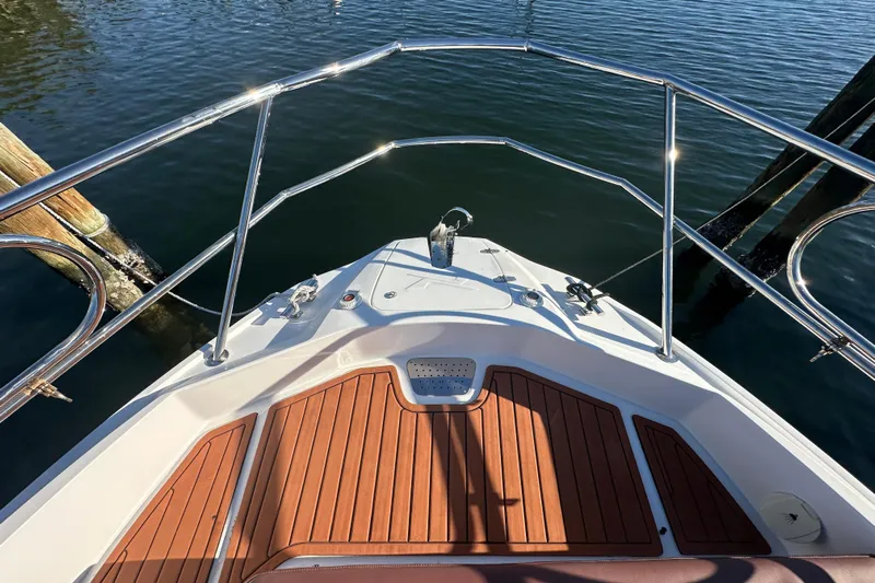  Yacht Photos Pics Bow view of 2025 NX Boats 370 with teak deck and stainless steel railings.