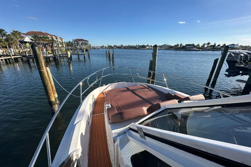  Yacht Photos Pics 2025 NX Boats 370 docked in a scenic marina under clear blue skies.