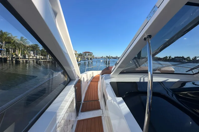  Yacht Photos Pics 2025 NX Boats 370 yacht with sleek design and wooden deck, cruising on a sunny day.