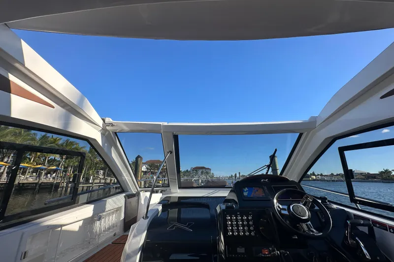  Yacht Photos Pics 2025 NX Boats 370 cockpit view with clear blue sky and waterfront scenery.