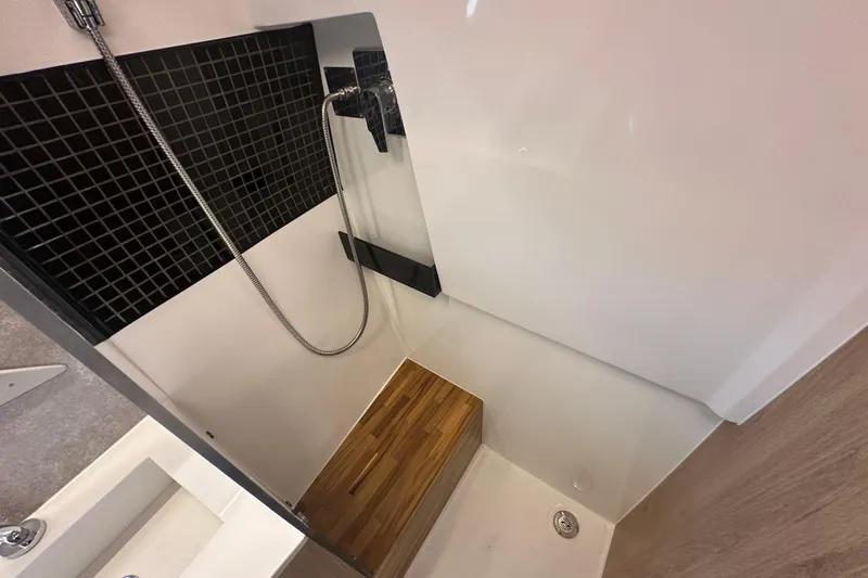  Yacht Photos Pics Modern shower area in 2025 NX Boats 370, featuring sleek design and wooden accents.