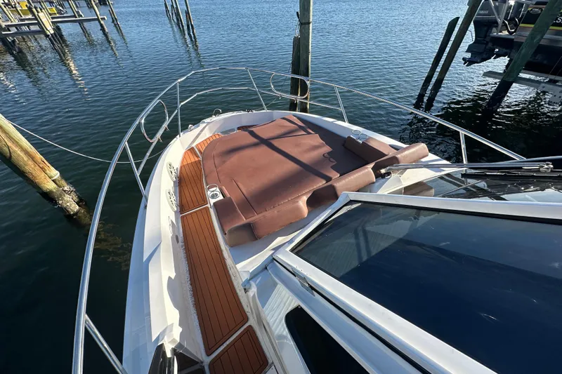  Yacht Photos Pics 2025 NX Boats 370 with sun deck, docked on calm water.