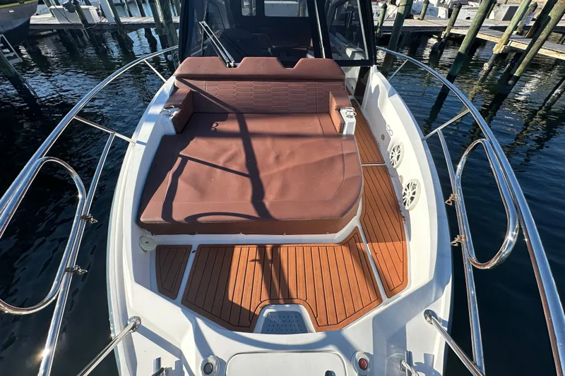  Yacht Photos Pics 2025 NX Boats 370 with brown seating and wooden deck, docked at marina.